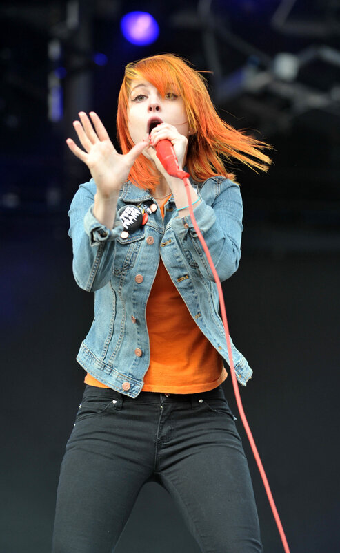 Woman Singing on Stage — Orange, Energetic, Night, Photograph, Microphone, Denim Jacket