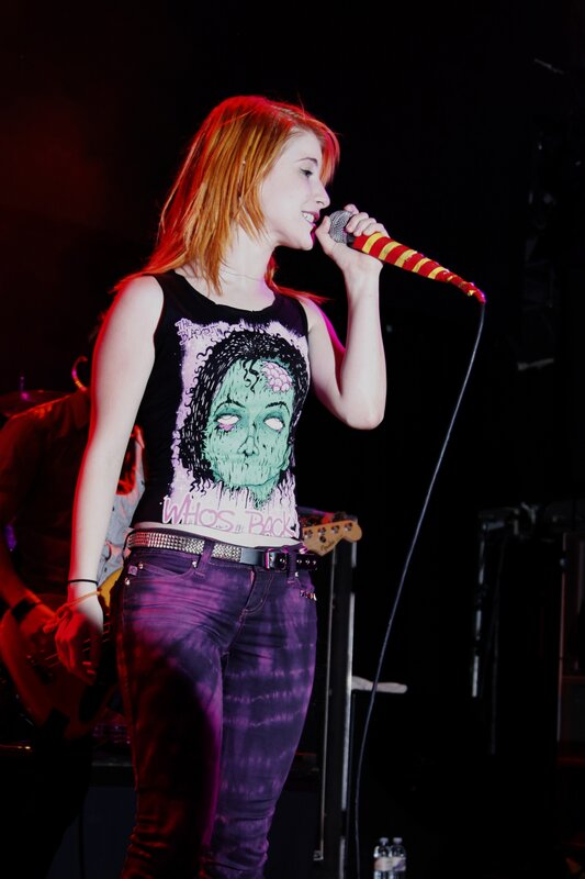 Woman Singing on Stage — Purple, Energetic, Night, Photograph, Microphone, Guitar