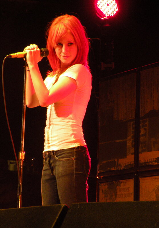 Woman Singing on Stage — Red, Dramatic, Night, Photograph, Microphone, Stage Light