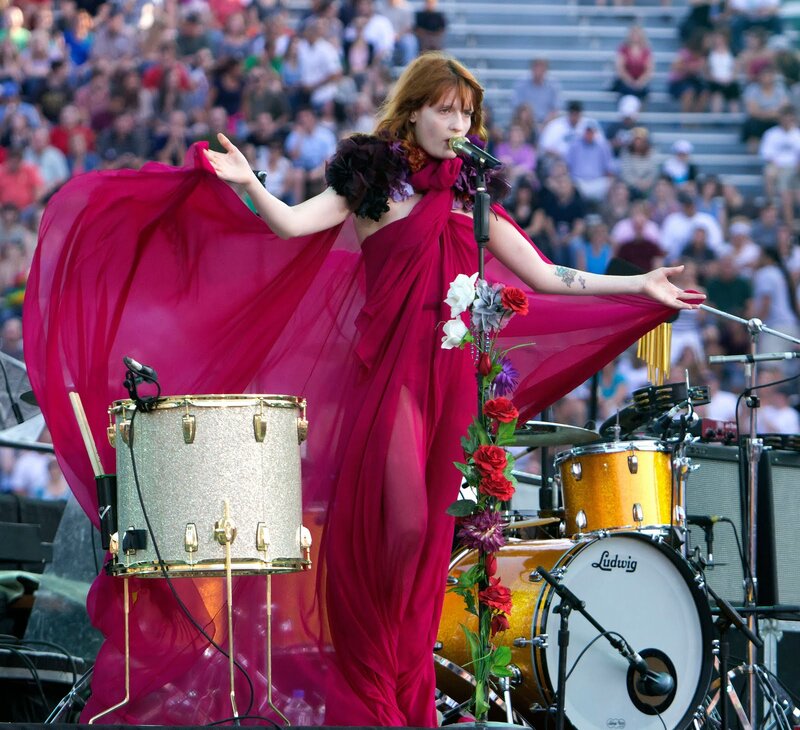 Woman Singing on Stage — Red, Energetic, Afternoon, Photograph, Drum Kit