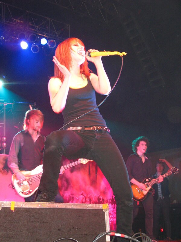 Woman Singing on Stage — Red, Energetic, Night, Photograph, Band Members
