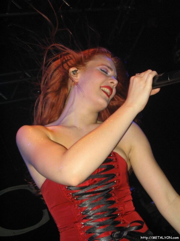 Woman Singing on Stage — Red, Energetic, Night, Photograph, Microphone, Corset