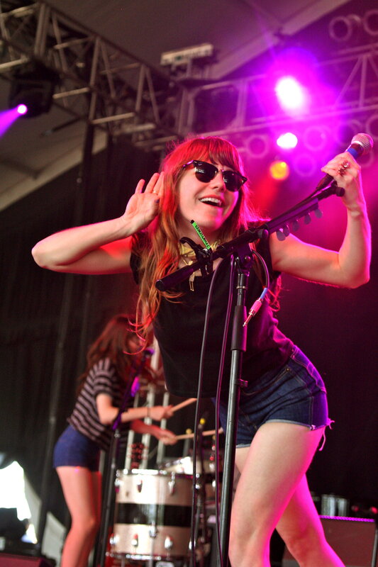Woman Singing on Stage — Red, Energetic, Night, Photograph, Microphone, Drums