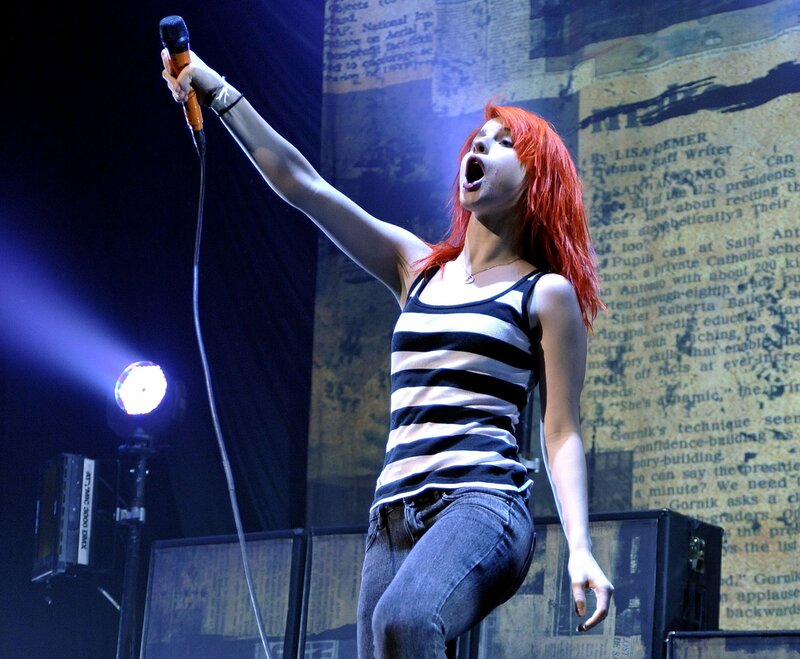 Woman Singing on Stage — Red, Energetic, Night, Photograph, Microphone, Stage Light