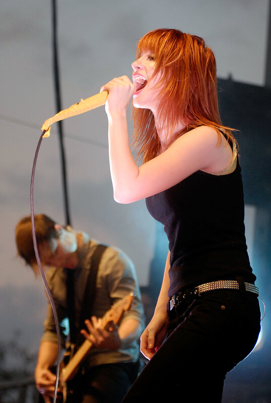 Woman Singing on Stage — Red, Energetic, Photograph, Guitarist