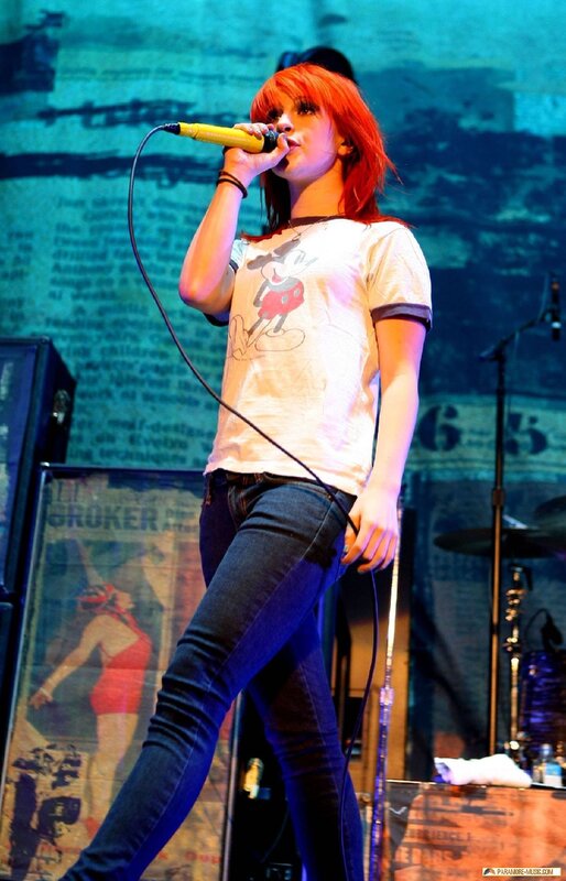 Woman Singing on Stage — Red, Energetic, Photograph, Microphone, T-shirt