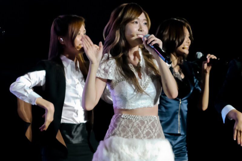 Woman Singing on Stage — White, Energetic, Night, Photograph, Microphone, Stage Lights, Performers
