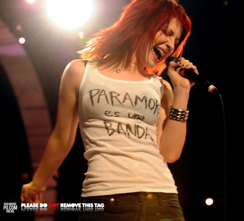 Woman Singing on Stage — White, Energetic, Night, Photograph, Microphone, Tank Top