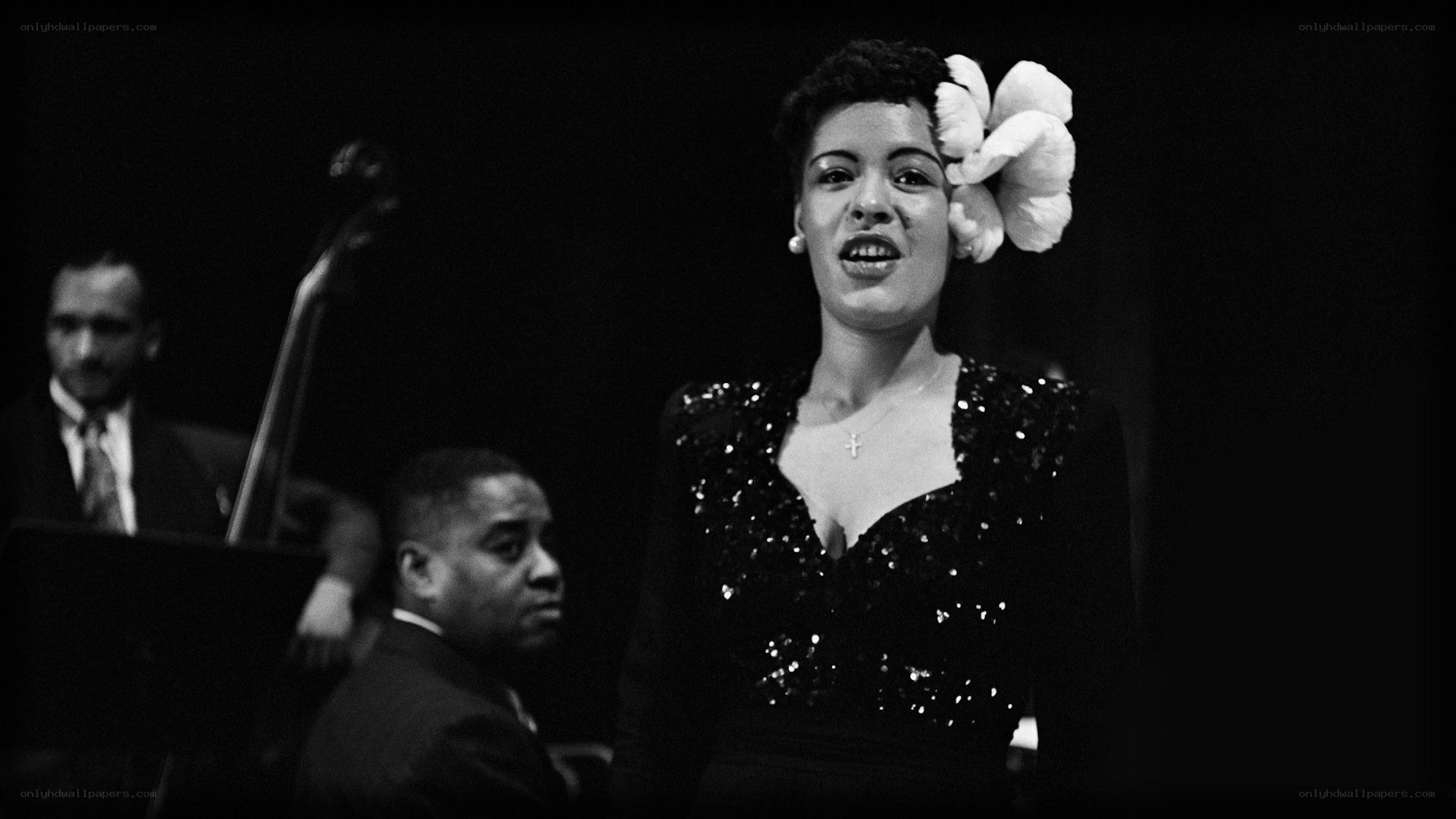Woman singing on stage with band