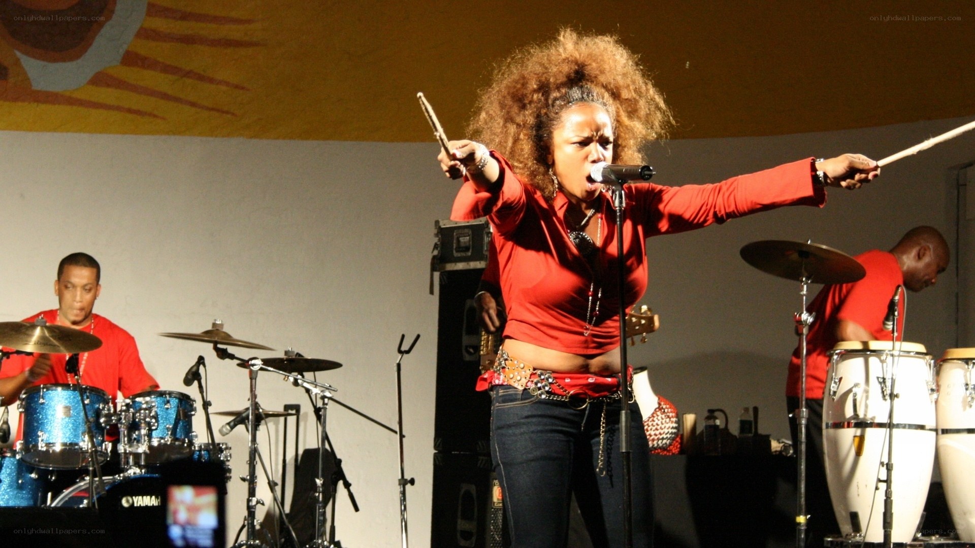 Woman singing on stage with band