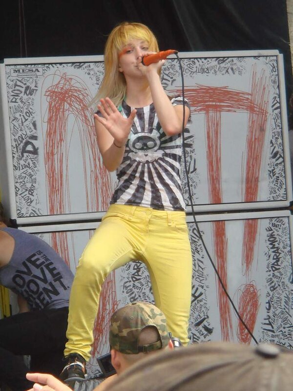 Woman Singing on Stage — Yellow, Energetic, Afternoon, Photograph, Microphone, Crowd