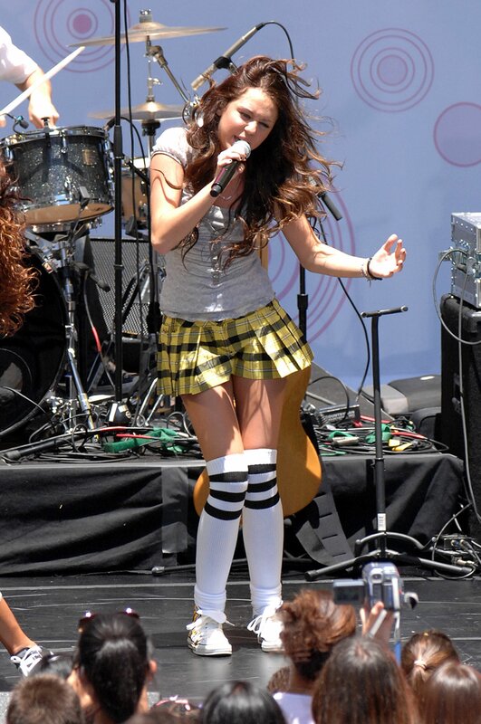 Woman Singing on Stage — Yellow, Energetic, Afternoon, Photograph, Microphone, Drum Kit