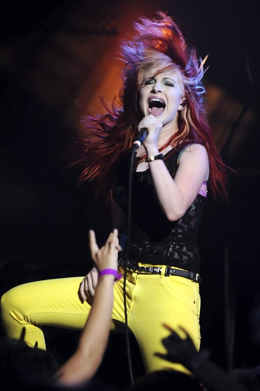 Woman Singing on Stage — Yellow, Energetic, Night, Photograph, Microphone, Audience Hands