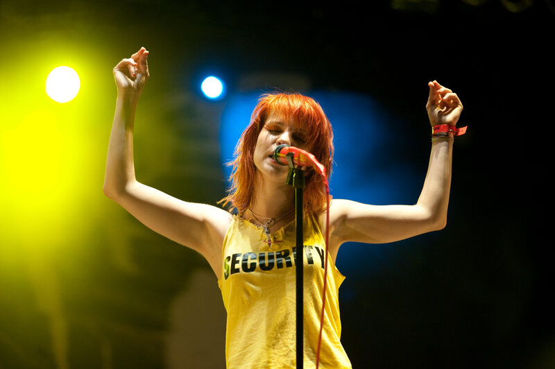 Woman Singing on Stage — Yellow, Energetic, Night, Photograph