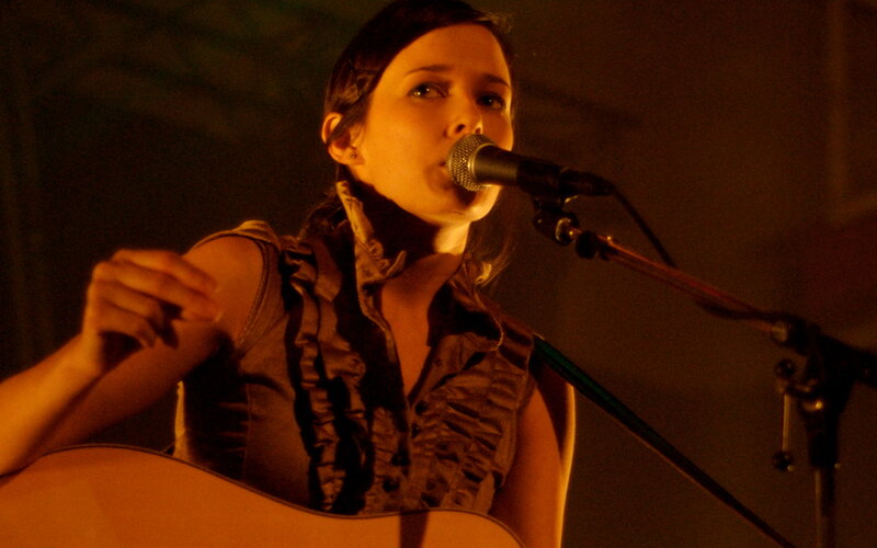 woman singing with guitar
