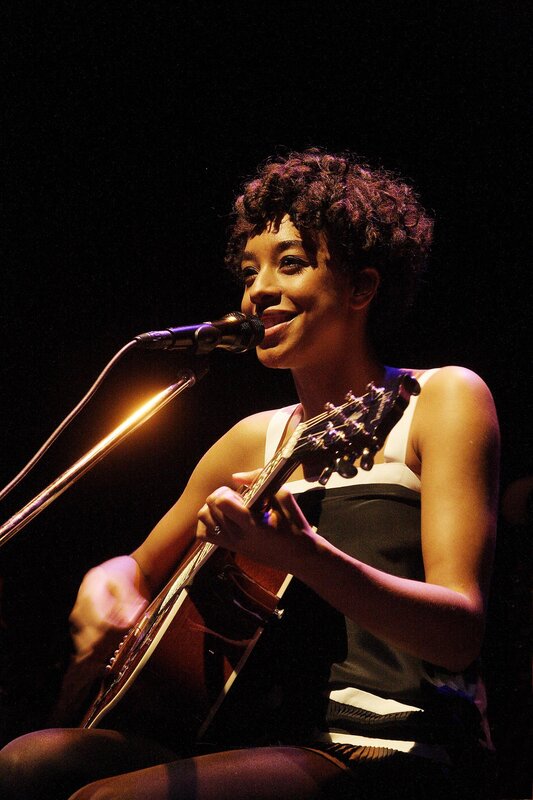 woman singing with guitar