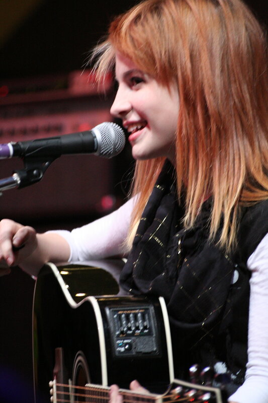 woman singing with guitar