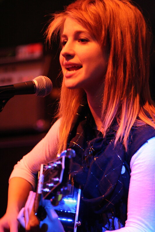 woman singing with guitar