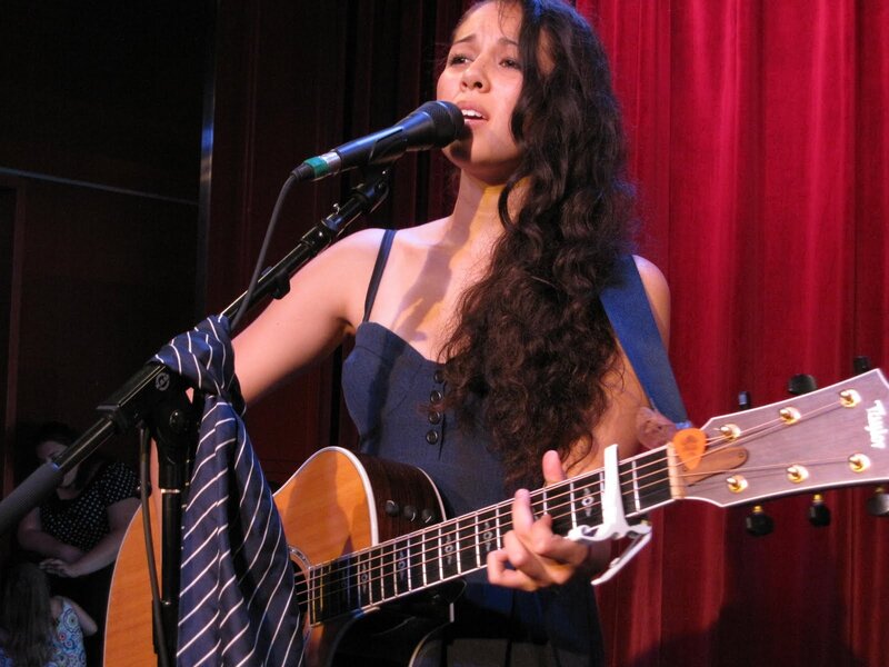 woman singing with guitar