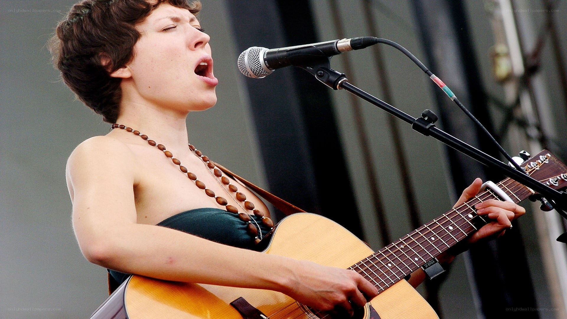 woman singing with guitar