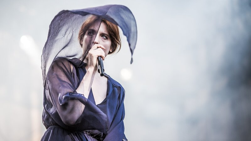 Woman singing with sheer fabric