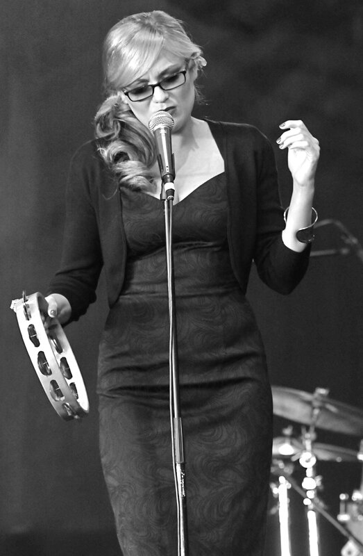 woman singing with tambourine