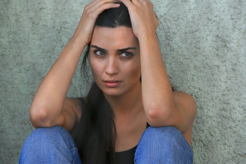 woman sitting against wall