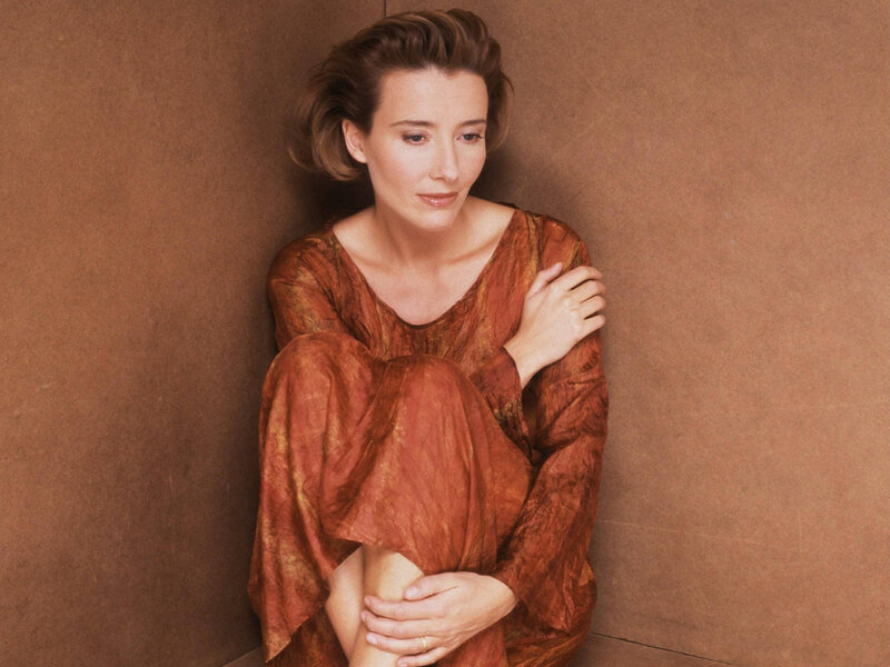 Woman Sitting Against Wall — Brown
