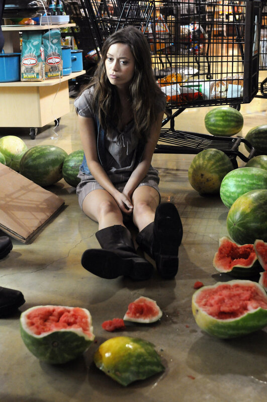 Woman sitting among watermelons