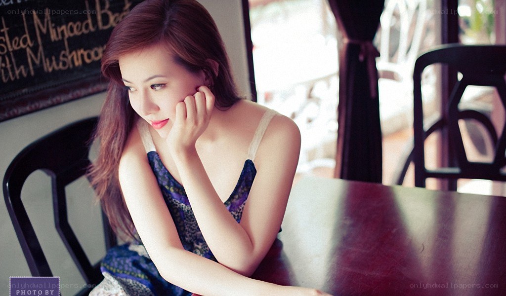 woman sitting at a cafe table
