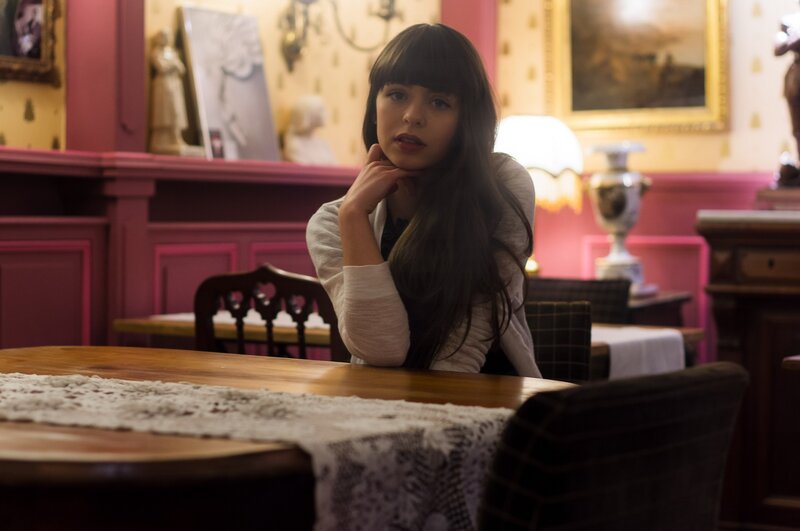 woman sitting at a table in a restaurant