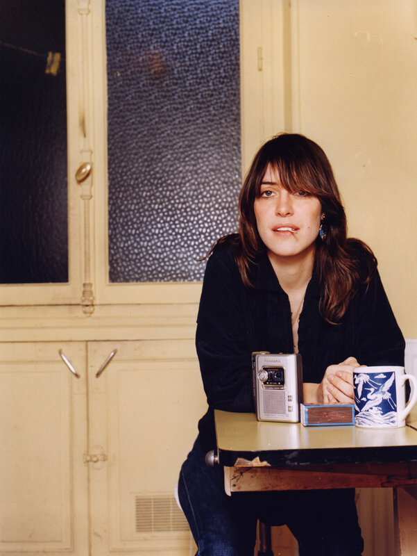 woman sitting at a table with mug