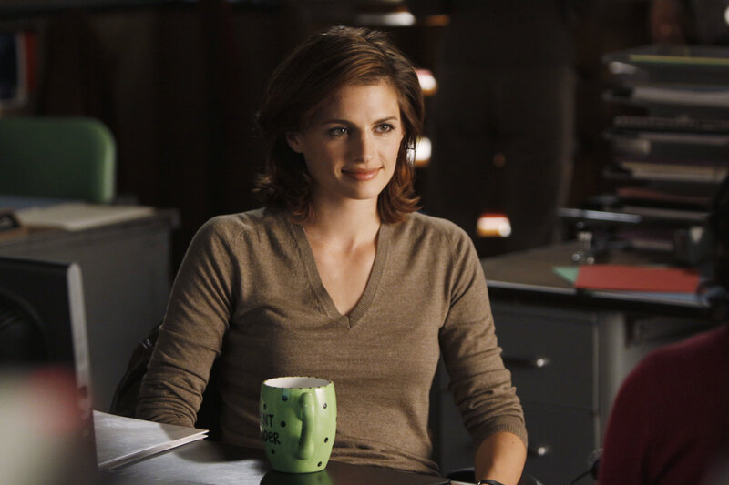 woman sitting at desk with mug