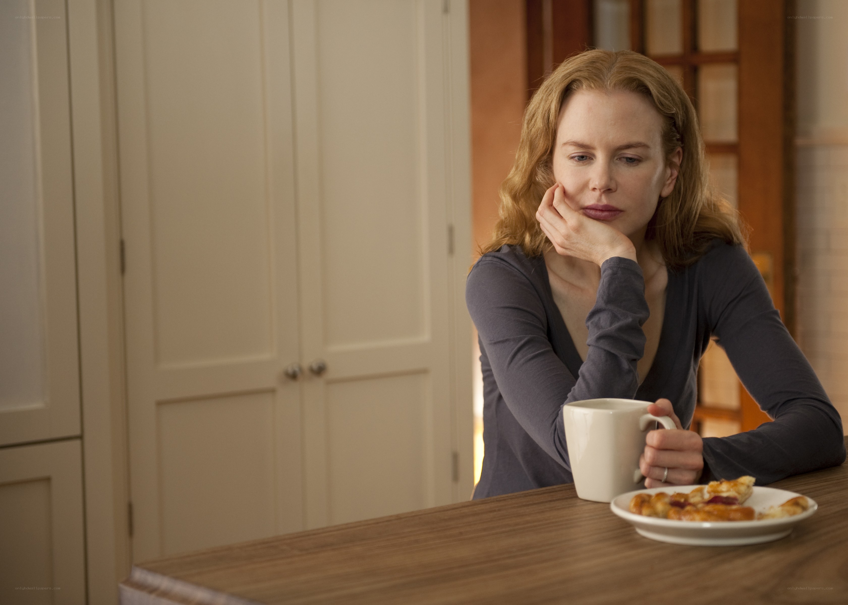 woman sitting at kitchen table