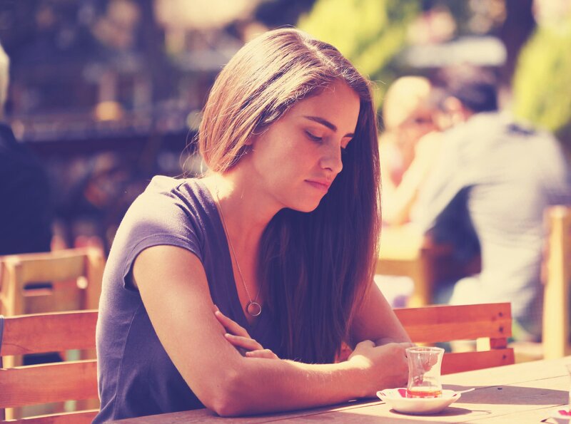 woman sitting at outdoor table