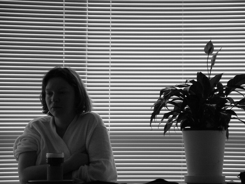 Woman Sitting at Table — Black