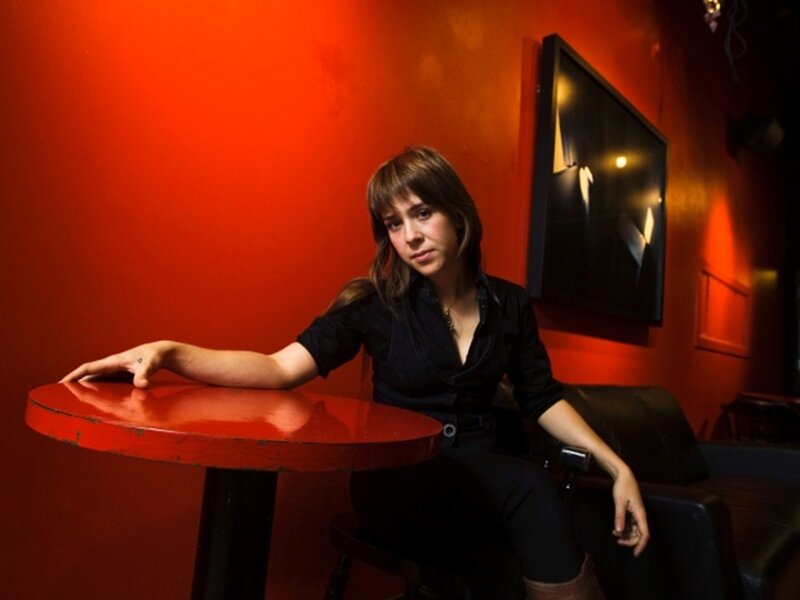 Woman Sitting at Table — Red