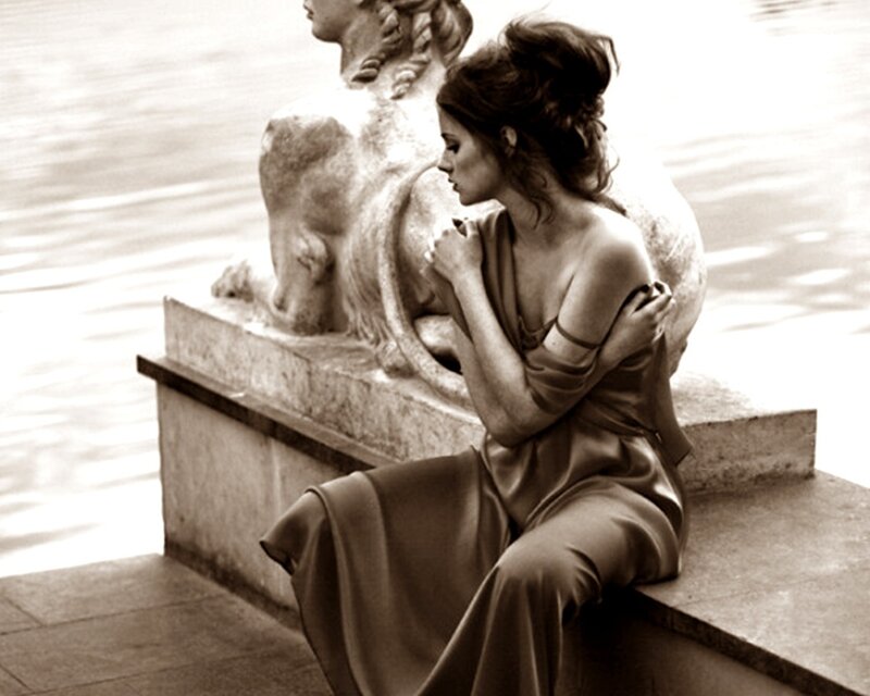 woman sitting beside a statue