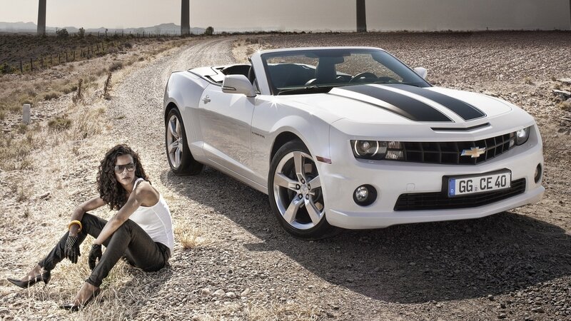 Woman Sitting Beside Car — White, Dramatic, Afternoon