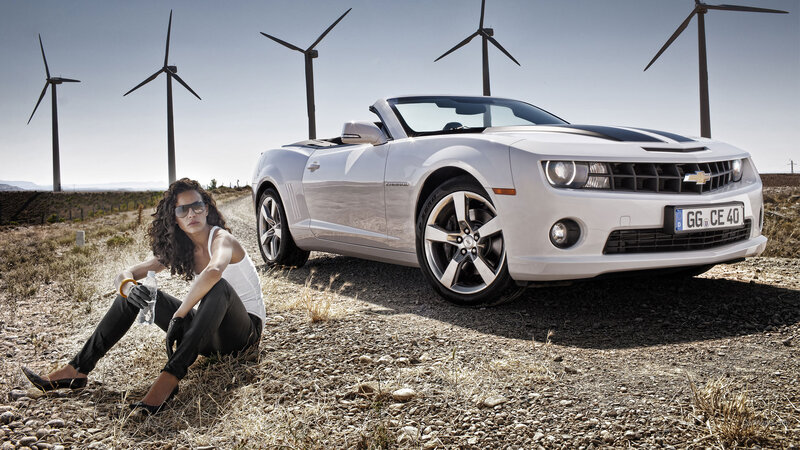 Woman Sitting Beside Car — White, Dramatic