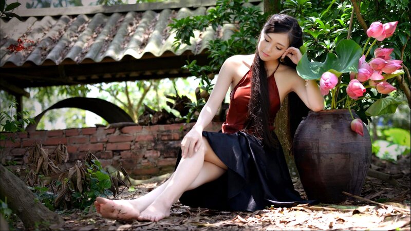 Woman Sitting Beside Lotus