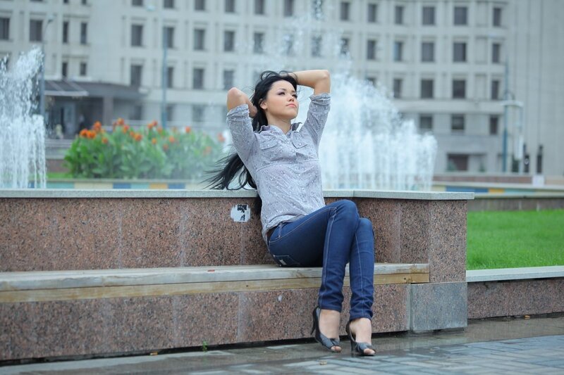 Woman sitting by a fountain