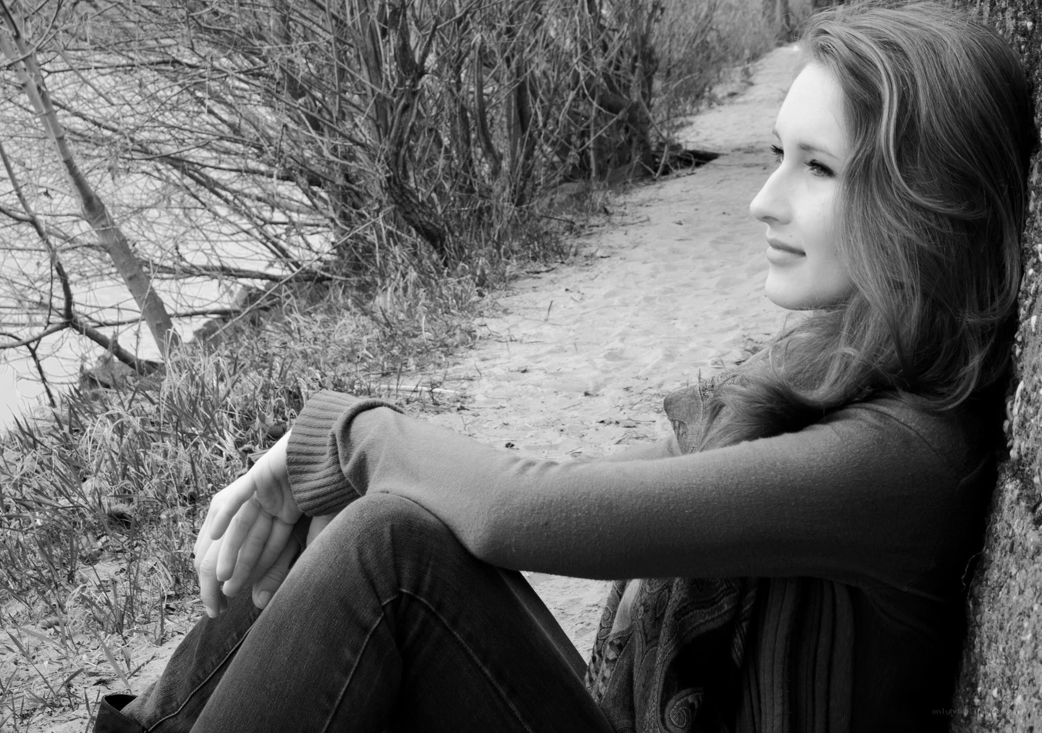 woman sitting by a path