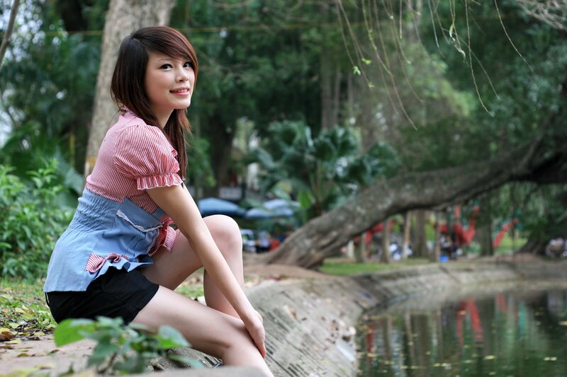 Woman sitting by a pond