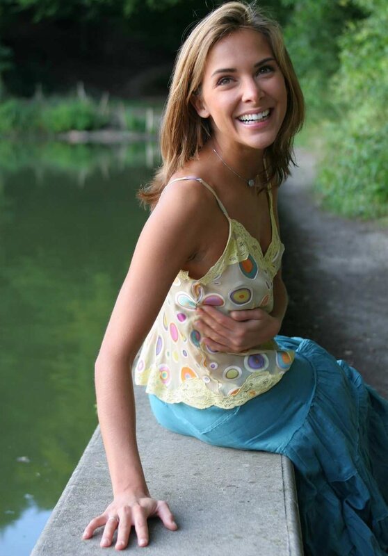 woman sitting by a pond