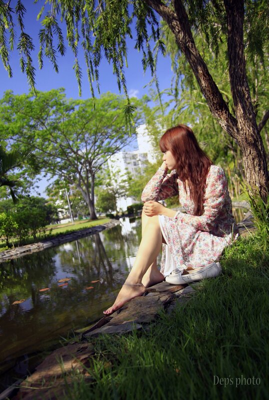 Woman sitting by a pond