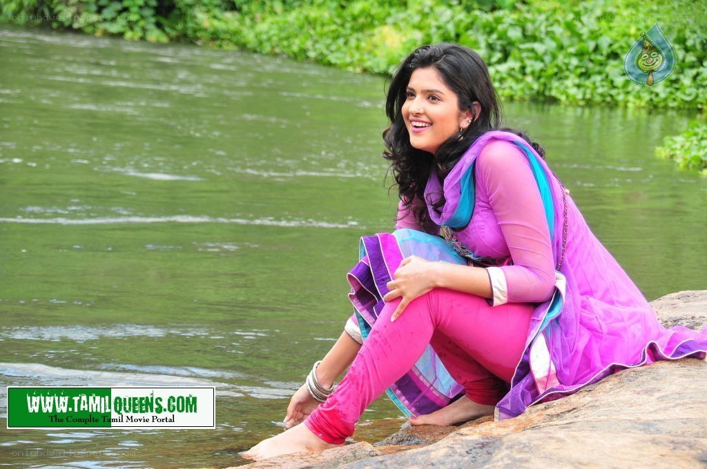 woman sitting by a river