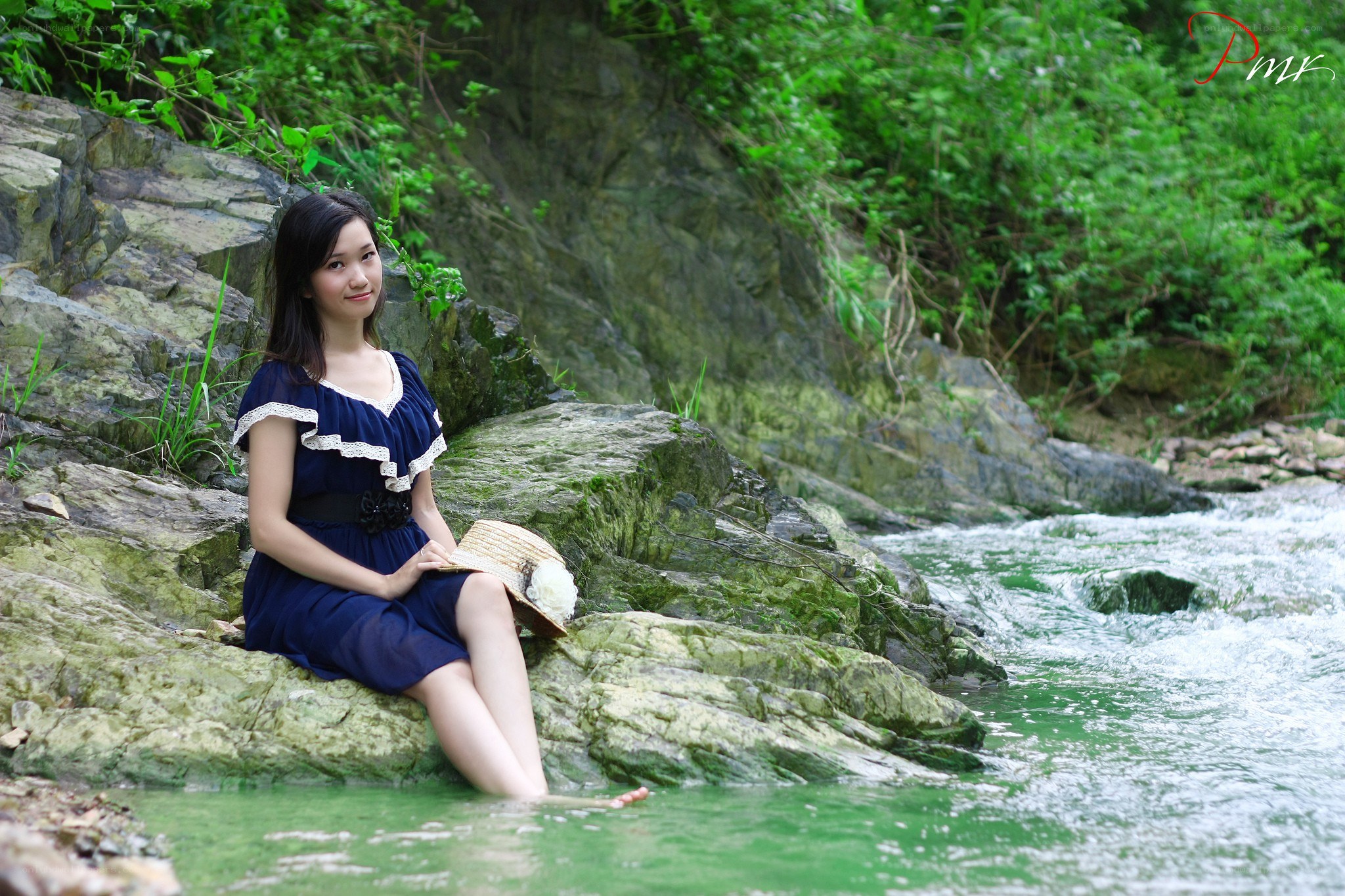 Woman sitting by a stream