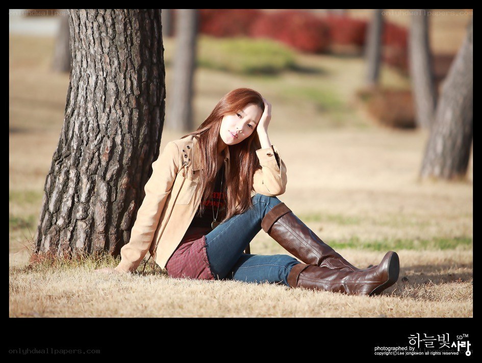 Woman sitting by a tree