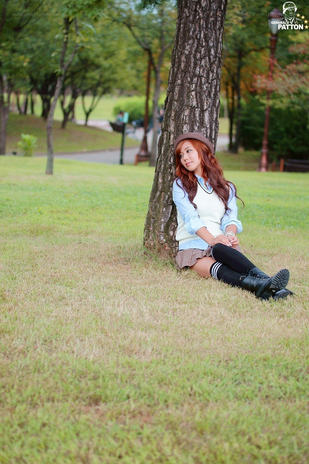 Woman sitting by a tree